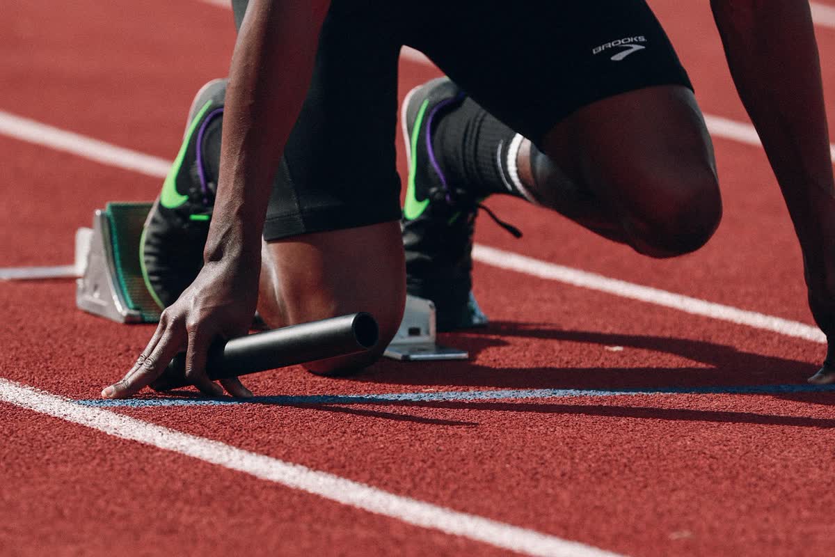 A sprinter set in the blocks on a running track